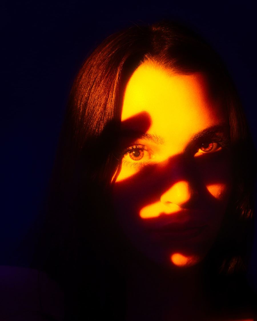 Portrait with orange coloured light and blue background