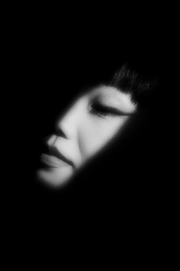 Half-lit face emerging from darkness, B&W